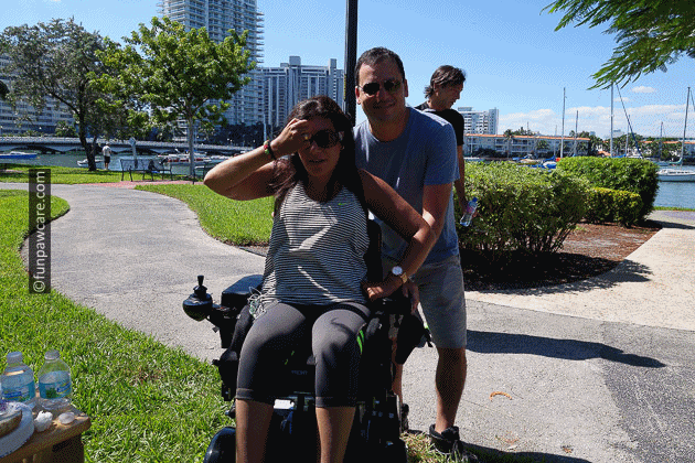 Sabrina Cohen fixing hair in wheelchair